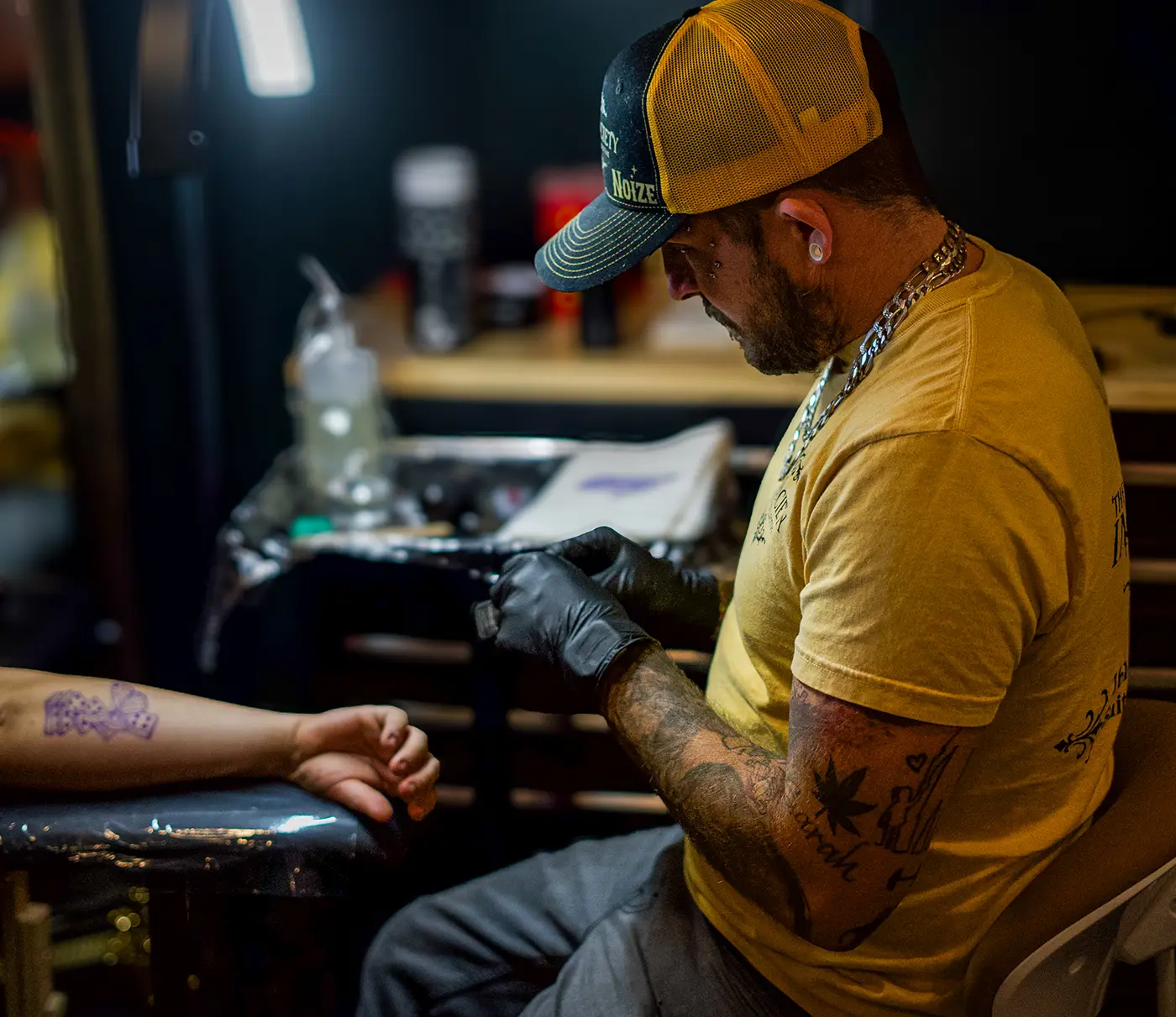 Noize Pierce making a leg tattoo on the calf