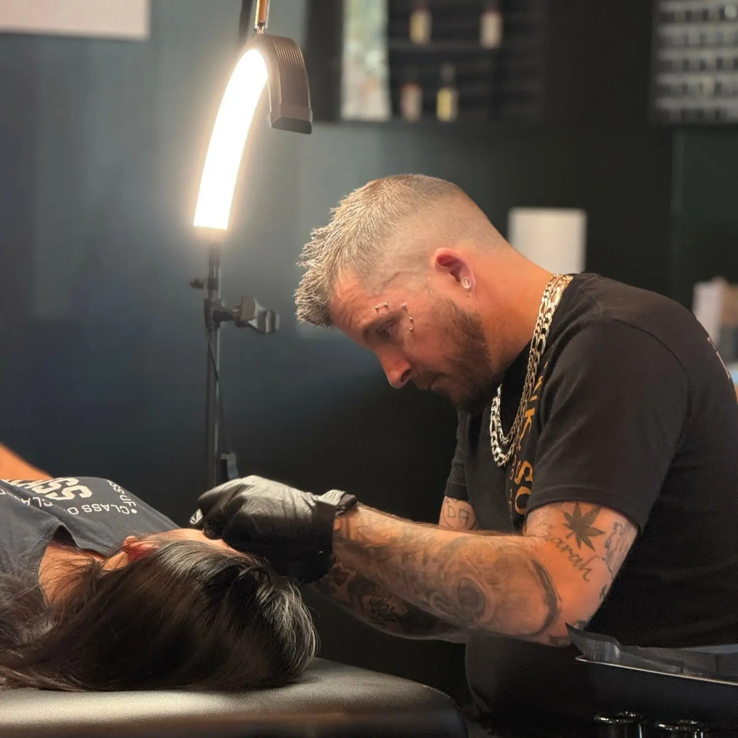 Professional piercer and shop owner, Noize Pierce, aligning a new piercing